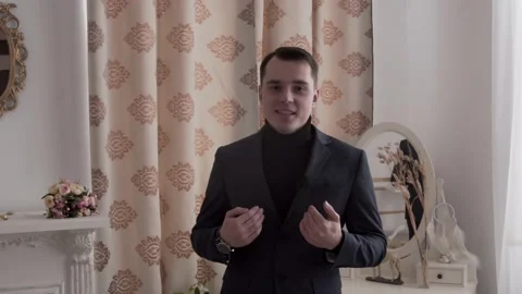 The guy is talking to the camera. In a classic suit. Stock Footage 130222565