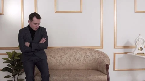 The guy is talking to the camera. In a classic suit. The guy is sitting Stock Footage 130222961