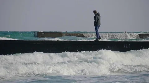 A guy talking on a mobile phone on a pier during a storm. Stock Footage 82213669