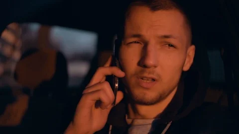The guy is talking on the phone in his car. He is very pleased with this Stock Footage 89010084
