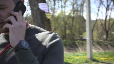 The guy talking on the phone on nature Stock Footage 95999955