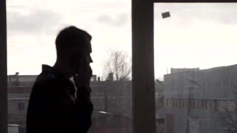 The guy talks in a fire uniform over the phone. In a buiding. Stock Footage 130229062