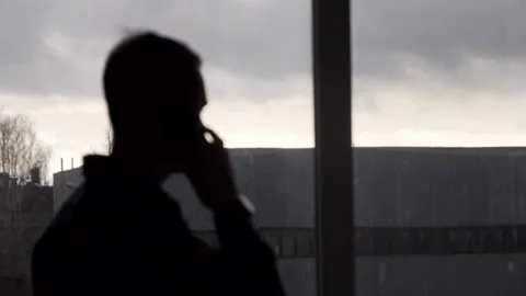 The guy talks in a fire uniform over the phone. In a buiding. Stock Footage 130229183