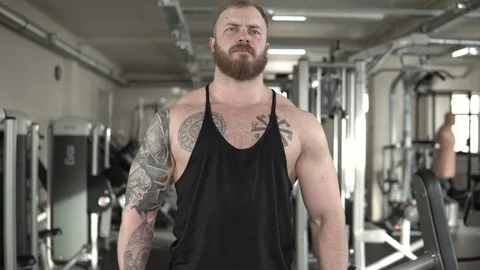 Guy with a tattoo trains with a dumbbell close-up 4k. Stock Footage 85594075