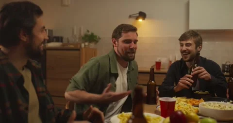 A guy tells an interesting story while holding a bottle of beer in his hand at a Stock Footage 313275137