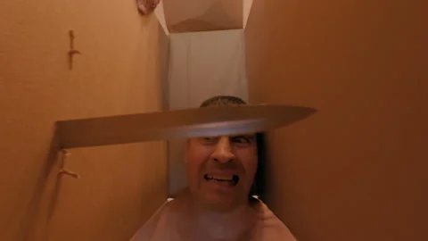 The guy is threatened with a knife, piercing the box in front of his face. Stock Footage 317177110