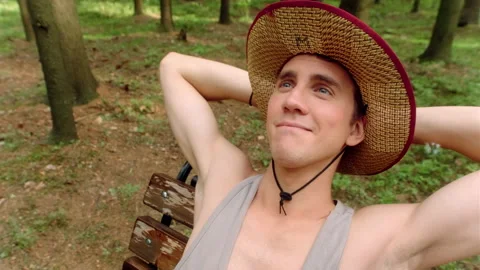 A guy threw his hands behind his head and was dreaming of something. Stock Footage 197480225