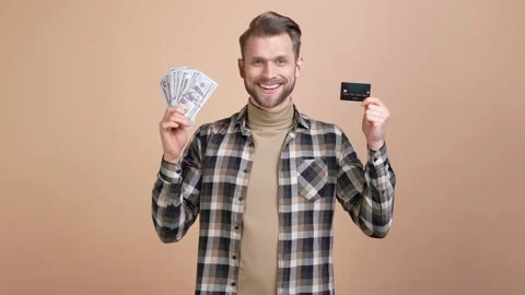 Guy throw hundred usd hold credit card profit isolated pastel color background Stock Footage 176786357