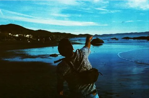 Guy Throwing Something At Beach Stock Photos