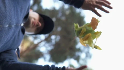Guy throws up autumn leaves Stock Footage 102784470