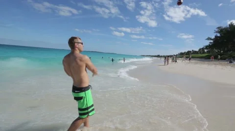 Guy Throws Ball On Beach of the Bahamas Video stock 46875715
