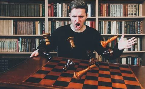 The guy throws the chess table. Chess pieces in flight. Winners and losers. Stock Photos