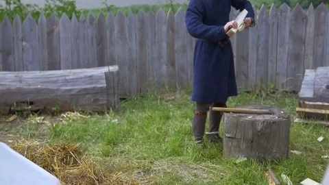 Guy throws firewood on the grass Stock Footage 82402644
