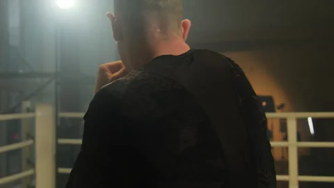 Guy throws punches and practices skills standing in ring Stock Footage 306666877