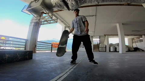 Guy throws a skateboard on a concrete floor Stock Footage 102320540