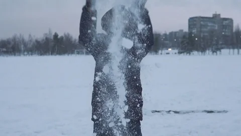 The guy throws snow over himself Stock Footage 83709728