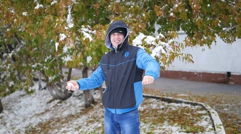 Guy throws a snowball in the autumn park Vidéo 68444730