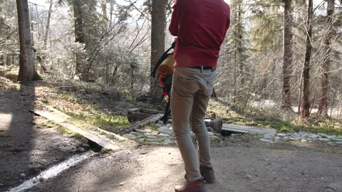 The guy ties the laces on brown boots standing on one knee on the ground. Stock Footage 195208158