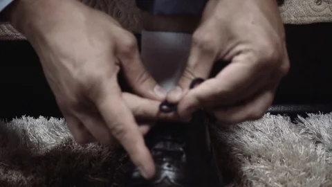 Guy ties shoelaces Stock Footage 96000283