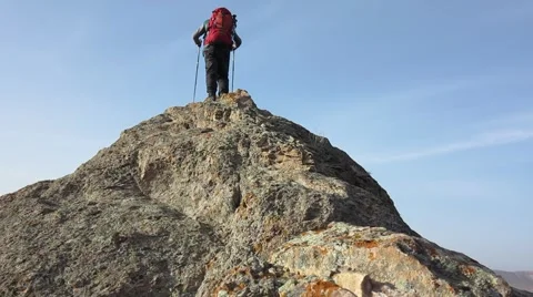 Guy on the top of a boulder Stock Footage 61160211
