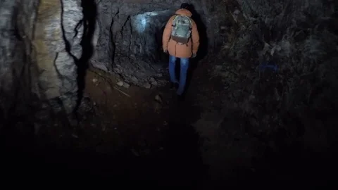 A guy with a torch goes to the cave Stock Footage 71748089