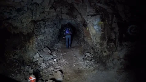 A guy with a torch goes to the cave Stock Footage 71750666