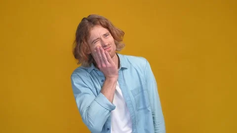 Guy touch cheek face strong severe tooth hurt isolated vivid color background Stock Footage 169277406