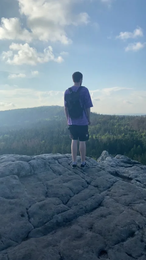 Guy tourist stands stone on the mountain Stock Footage 224723116