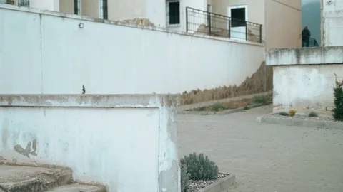 The guy is training parkour. Jumps on the railing on a cold autumn day. Does a Stock Footage 120240652
