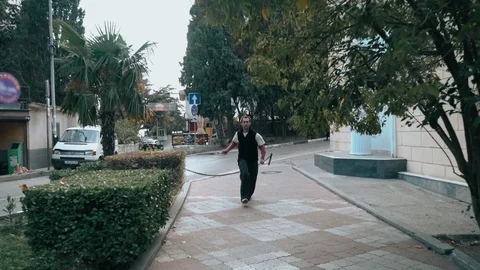 The guy is training parkour. Jumps on the railing on a cold autumn day. Does a Video stock 120241781