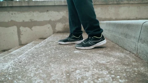 The guy is training parkour. Walking down the stairs in his arms. On a cold Stock Footage 120240736