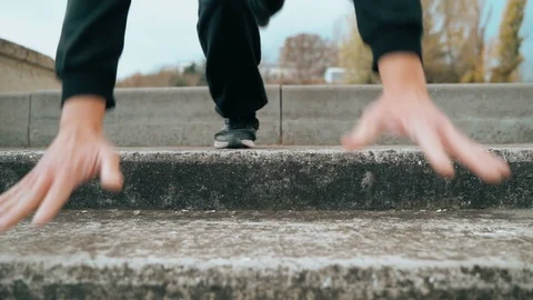 The guy is training parkour. Walking down the stairs in his arms. On a cold Video stock 120240923