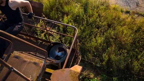 The guy trains on the crane of the abandoned construction site Stock Footage 79576691