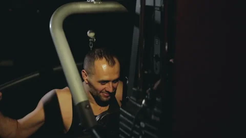 Guy trains his shoulders on the simulator Stock Footage 86897342