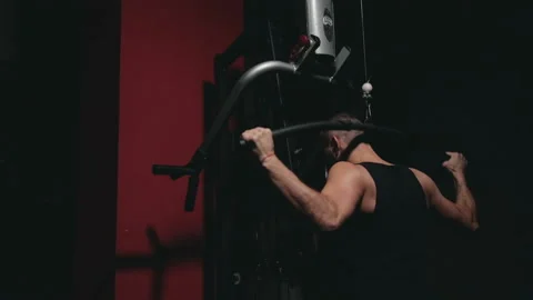 Guy trains his shoulders on the simulator Stock Footage 87077330