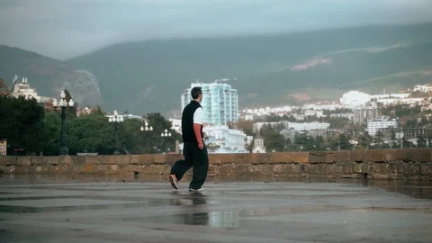 The guy trains parkour. The guy does a flip back flip against the backdrop of Video stock 120902267