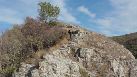 Guy with a travel backpack on the top of a boulder 스톡 동영상 56024723