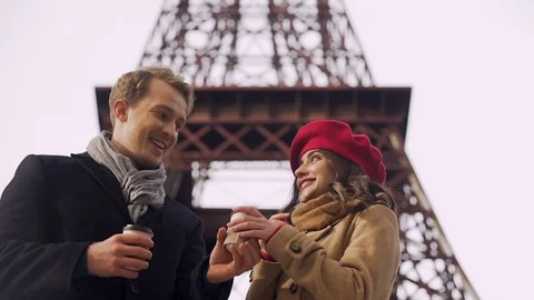 Guy treating his girlfriend with hot drink to keep warm, romantic trip in Europe Stock Footage 83905415