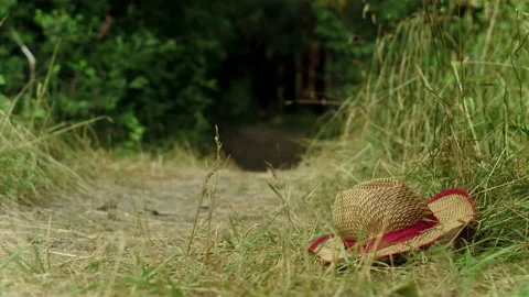 A guy tries to catch a straw hat that slips out of his hands. Stock Footage 197480172