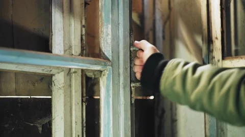 The guy tries to open the old window by the handle. Close - up of the hand Stock Footage 130662424