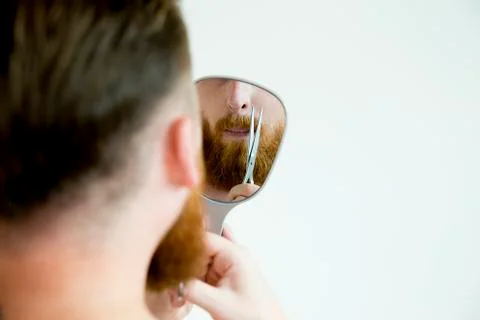 Guy trimming his beard Stock Photos