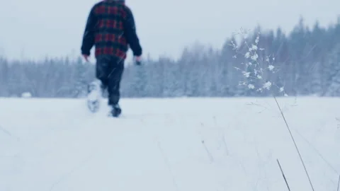 Guy trudges through thick fresh puffy winter snow in winter on edge of forest Stock Footage 331756082