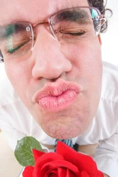 Guy trying to be romantic giving a kiss holding rose Stock Photos