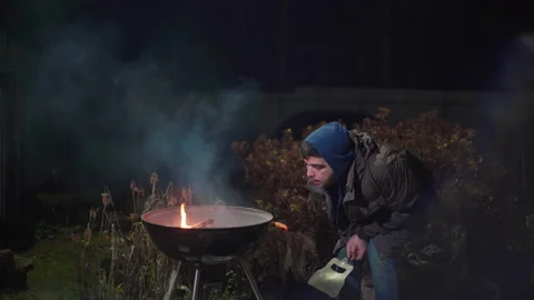 Guy trying to break a stick on his knee Stock Footage 166961133