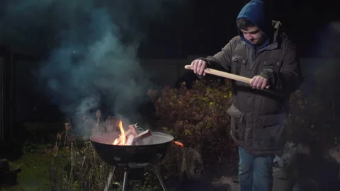 Guy trying to break a stick on his knee Stock Footage 166962723