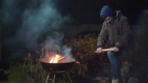 Guy trying to break a stick on his knee Stock Footage 166962857