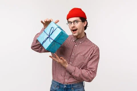 Guy trying make intrigue as prepared present for girlfriend, shaking wrapped box Stock Photos