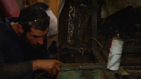 Guy turns away not to look at the welding sparks Stock Footage 80932113