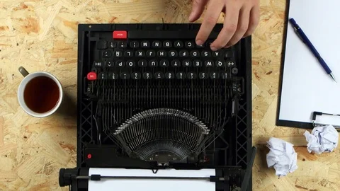 Guy type the text of the book on a typewriter. View from above Stock Footage