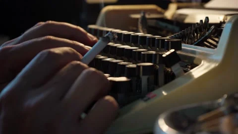 Guy types on an old typewriter and smokes cigarettes, writer, journalist Stock Footage 138812156
